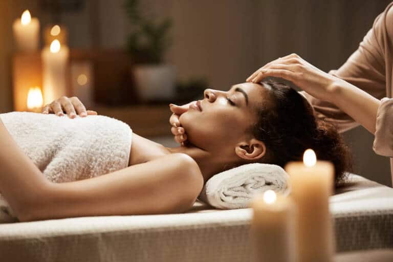 attractive-african-woman-enjoying-face-massage-spa-salon-1-scaled